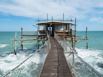 Pier over sea against sky