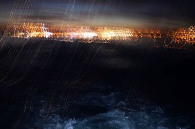 Aerial view of illuminated sea at night