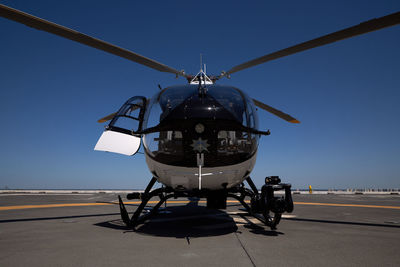 Airplane on airport runway against clear blue sky
