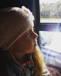 Close-up of boy looking through window