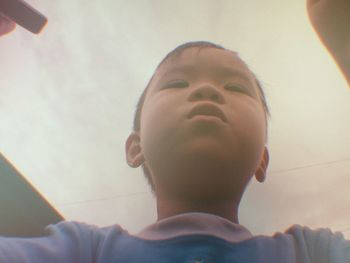 Low angle view of boy using mobile phone
