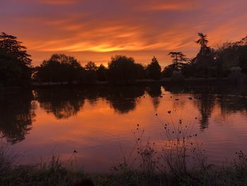 Scenic view of lake against orange sky