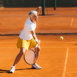 Beautiful mature woman at the tennis court