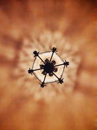 Low angle view of silhouette crane against sky