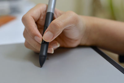 Close-up of man working in pen
