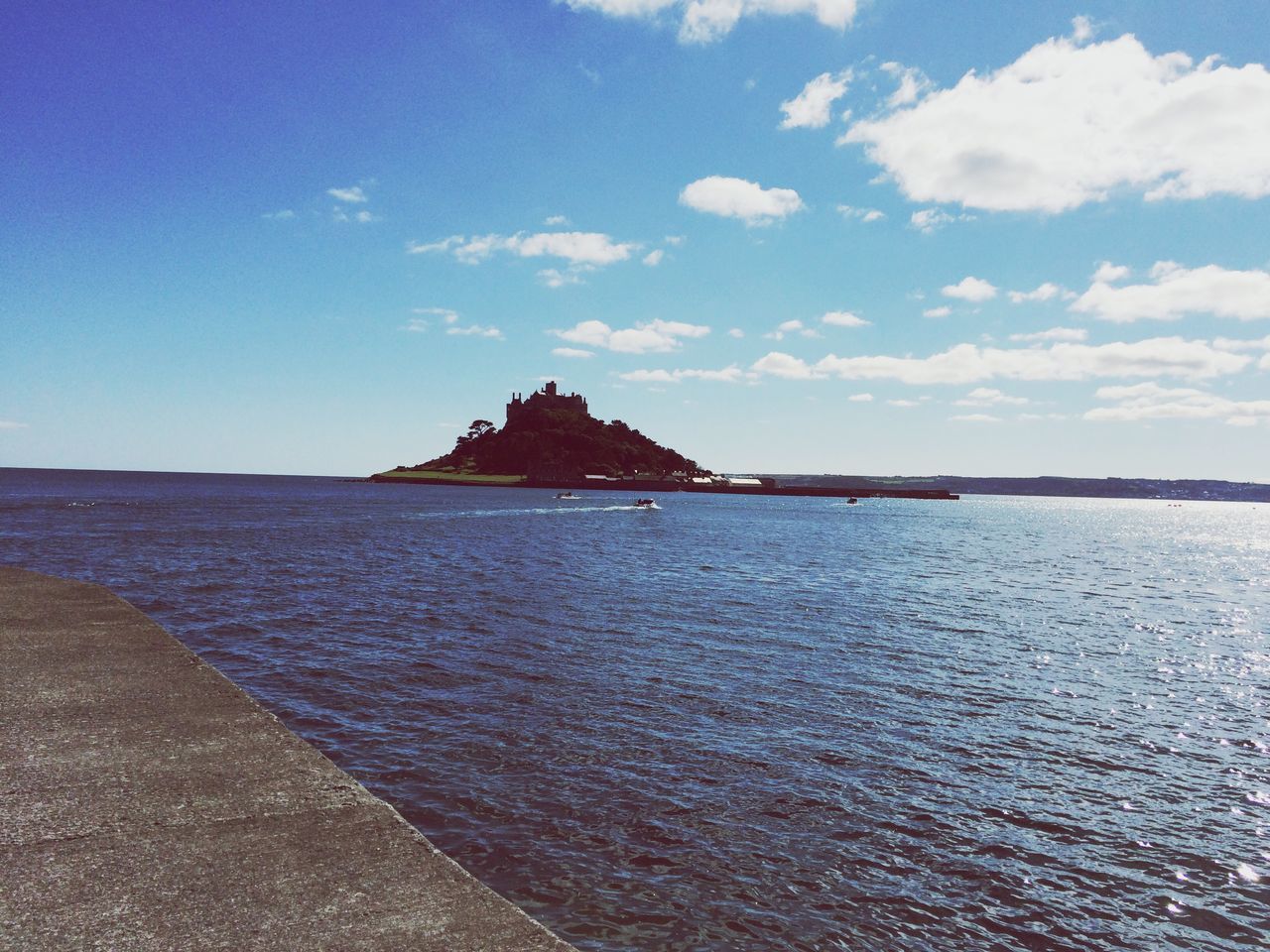 water, sea, building exterior, built structure, architecture, sky, waterfront, rippled, tranquil scene, tranquility, scenics, blue, nature, beauty in nature, cloud - sky, horizon over water, cloud, outdoors, day, idyllic