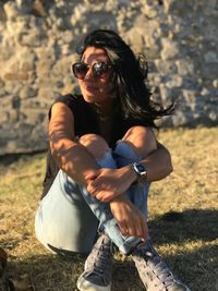 Young woman wearing sunglasses on field