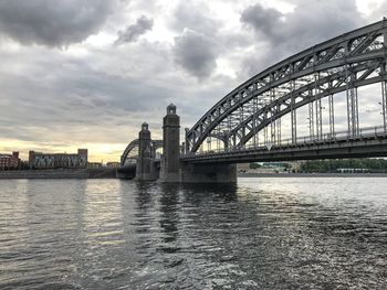 View of bridge over river against cloudy sky