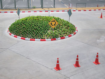 Small roundabout with traffic symbols and road cones