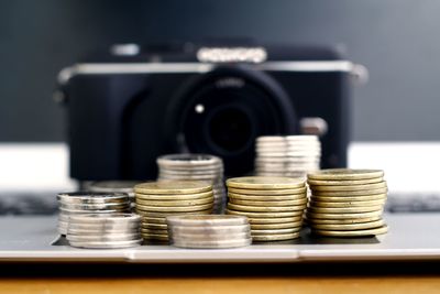 Close-up of coins on laptop against camera