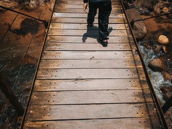 Low section of man standing on footpath