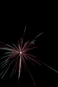 Low angle view of firework display at night