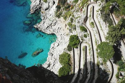 Panoramic view from above with a winding route to the beach of marina piccola and the turquoise sea.