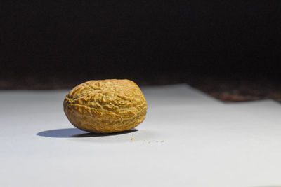 Close-up of bread on table against black background