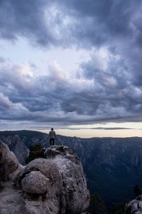 Rear view of man standing on cliff