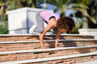 Full length of woman exercising on steps