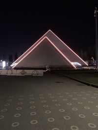 Illuminated bridge against sky at night