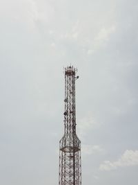 Low angle view of communications tower against sky