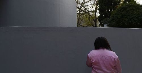 Rear view of man standing against tree