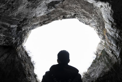 Rear view of man standing against clear sky