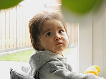 Portrait of cute girl sitting at home