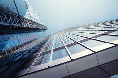 Low angle view of modern glass building against clear sky