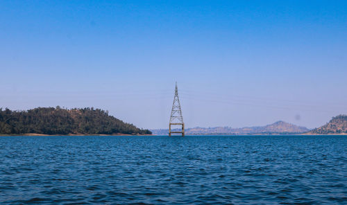 Scenic view of sea against clear blue sky