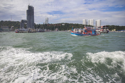 Scenic view of sea and buildings against sky