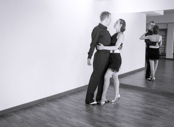 Full length of couple dancing at studio