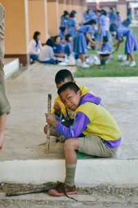 Portrait of smiling boy with friend at school campus