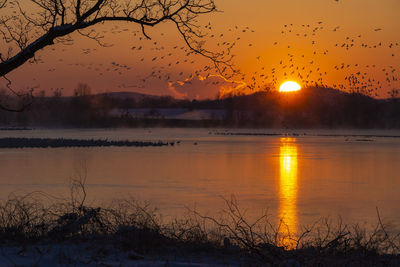 Scenic view of lake against sky during sunset