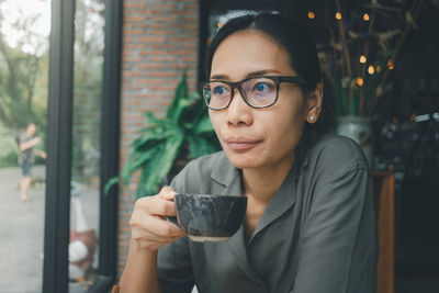 Portrait of young woman drinking drink