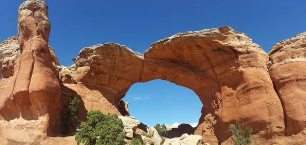 Low angle view of rock formations against blue sky