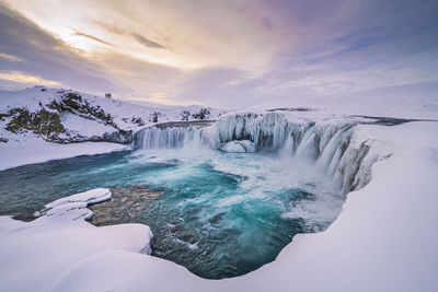 Scenic view of frozen lake against sky during winter