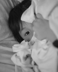 Close-up of child in bed