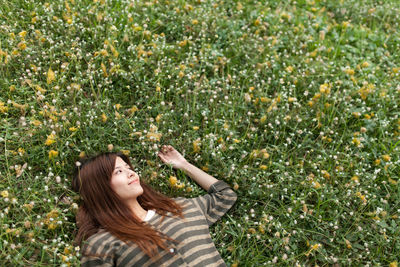 Portrait of woman lying on plant