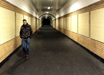 Man standing in illuminated corridor