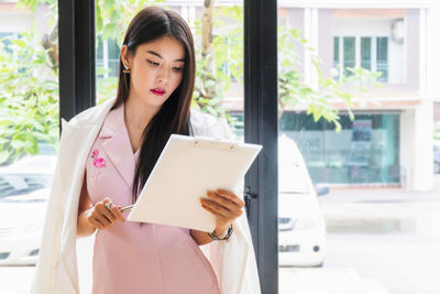 Woman standing by window