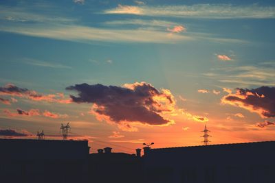 Low angle view of built structure against sky at sunset