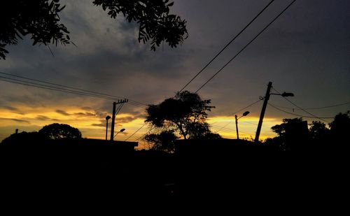 Low angle view of silhouette trees against sky during sunset