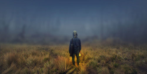 Rear view of man standing on field