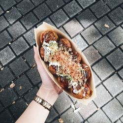 High angle view of person holding ice cream on street