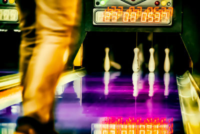Blurred motion of person standing in illuminated store