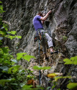 Full length of man climbing on rock