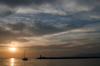 Sailboat in sea at sunset