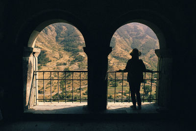 Rear view of silhouette woman looking at mountain while standing on observation point