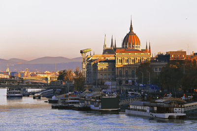 Hungarian parliament at sunrise on danube river, budapest, hungary