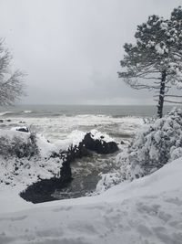 Scenic view of snow covered land against sky