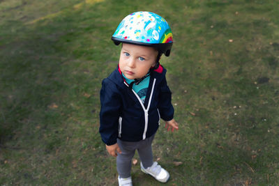 High angle view of cute boy standing on field