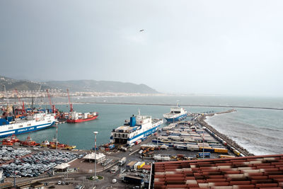 High angle view of harbor by sea against sky